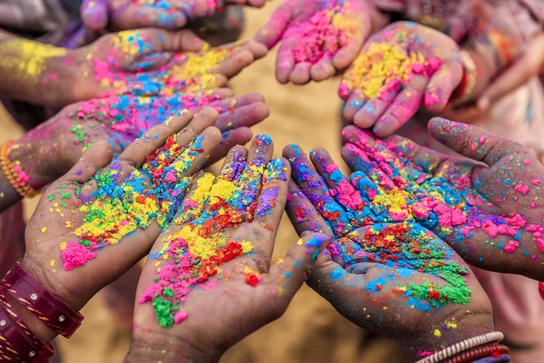 Holi celebration hands with colored powder