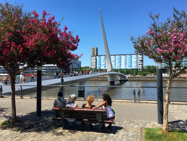 Group of women sitting on bench in Puerto Madero, Buenos Aires, Argentina