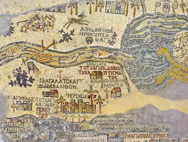 A detailed ancient mosaic map depicting rivers, buildings, and Greek inscriptions, featuring varied colors and intricate patterns.