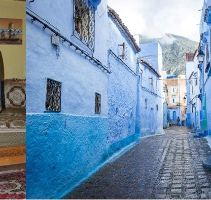 A person in traditional attire stands inside a home on the left. On the right, a narrow blue-painted street with buildings and mountains in the background.